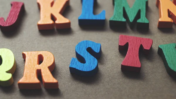 Lettres en bois colorées sur fond en bois Images De Stock Libres De Droits