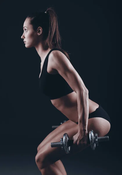Strong fit woman exercising with dumbbells — Stock Photo, Image