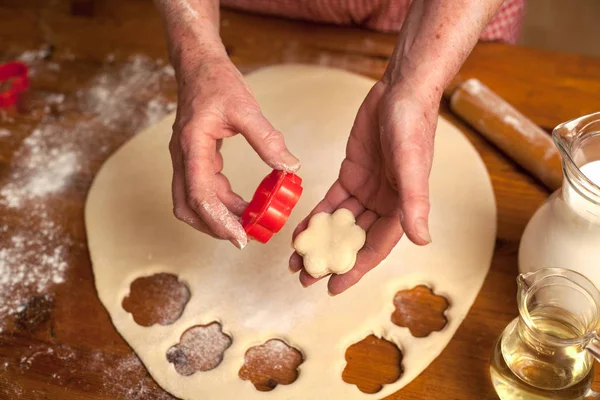 Rukou starší ženy připravují lahodné sušenky — Stock fotografie