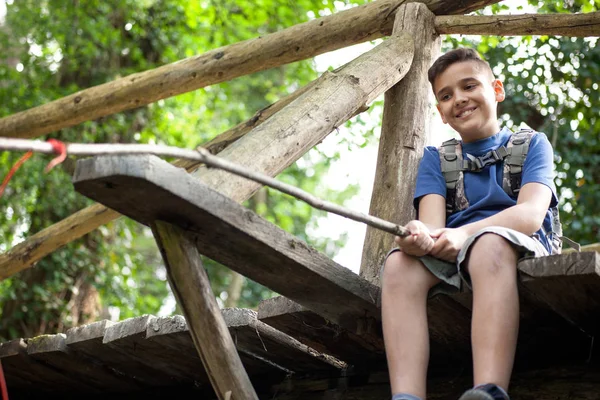 Young boy fishing in the woods on bridge — Stock Photo, Image