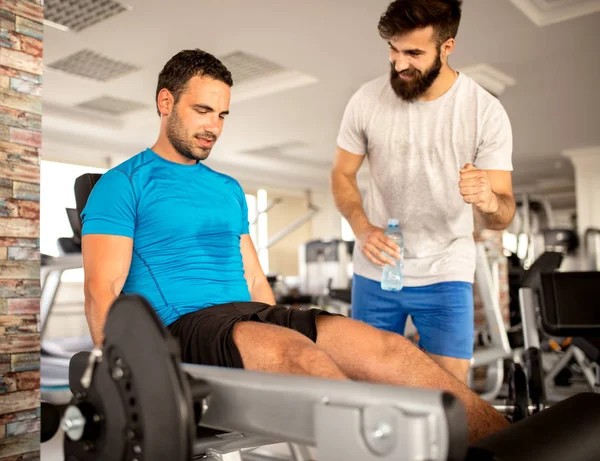 Personal trainer working with his client in gym — Stock Photo, Image