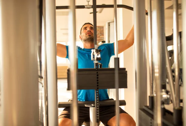 Man utbildning bröstet och rygg muskler på gymmet — Stockfoto