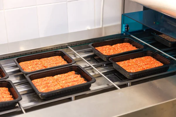 Packing of romanian traditional mititei on conveyor belt