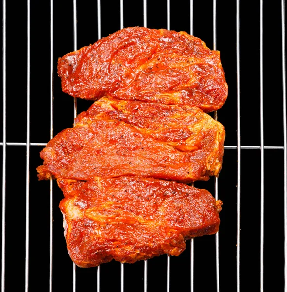 Marinated pork blade roast on barbecue grid
