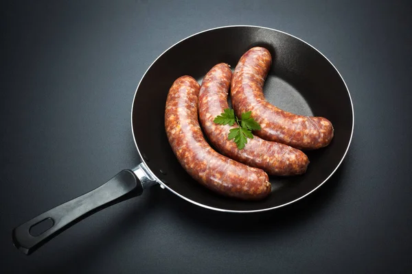 Pork sausages in frying pan — Stock Photo, Image