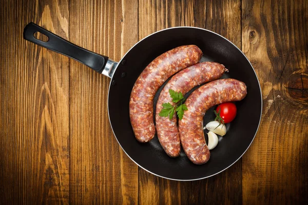 Top view of pork sausages in frying pan — Stock Photo, Image