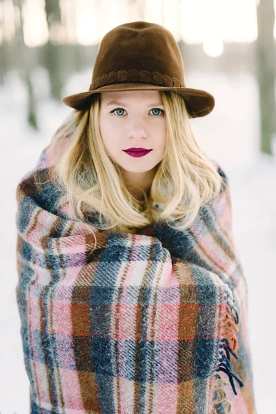 Girl in the hat wrapped in a blanket — Stock Photo, Image