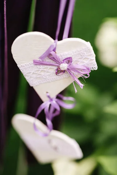 decoration in purple tones white wooden hearts, wedding decoration