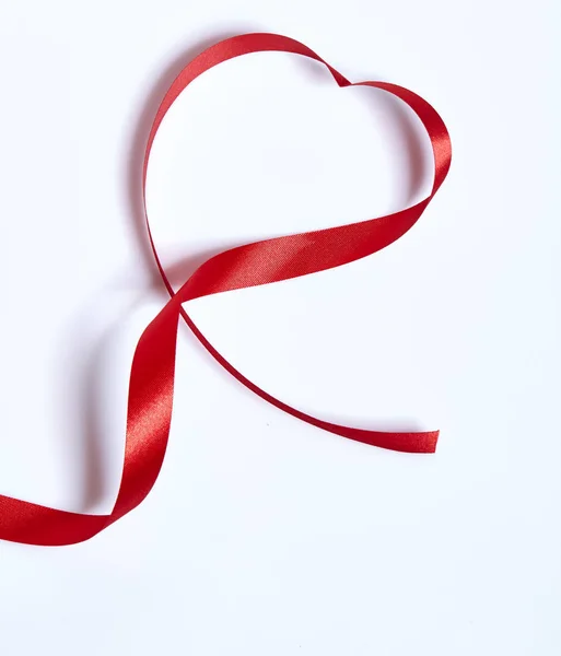 Red heart ribbon, on white background Stock Picture