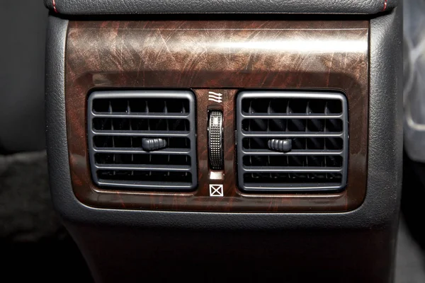 Cropped Image of a passenger air vents wood in a luxury vehicle