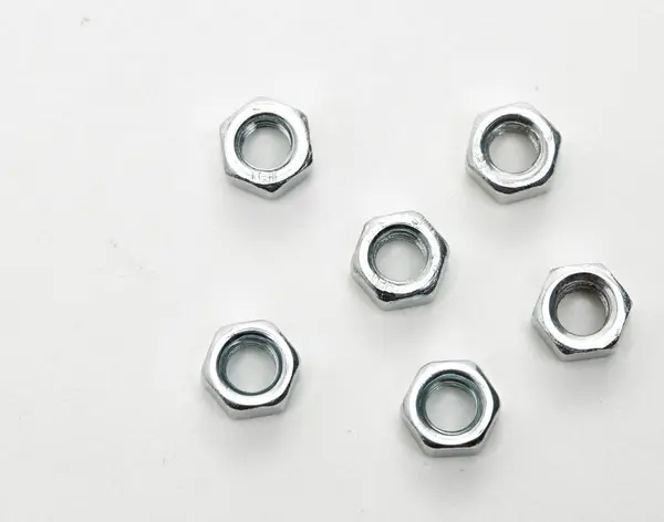 Nuts and bolts on white background — Stock Photo, Image