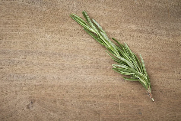 Rosemary on the old wooden table — Stock Photo, Image