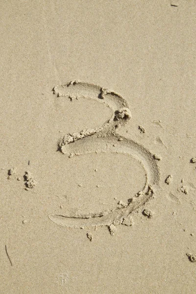 Números escritos en la arena — Foto de Stock