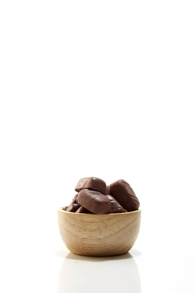 Chocolate candy in wooden bowl — Stock Photo, Image