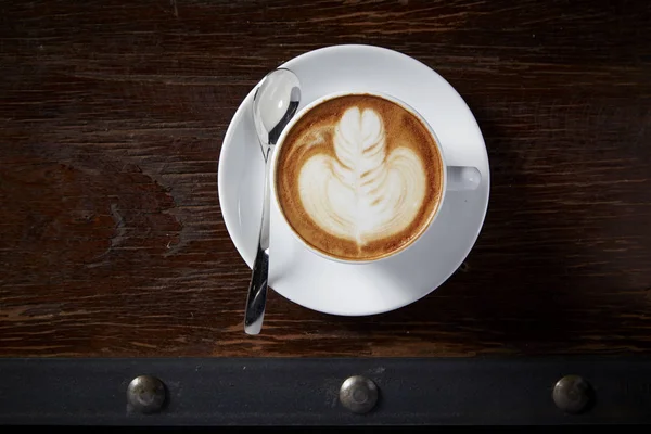 Cup of latte coffee on wooden table — Stock Photo, Image