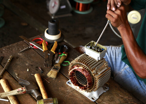 Repairman during maintenance work of electric motors