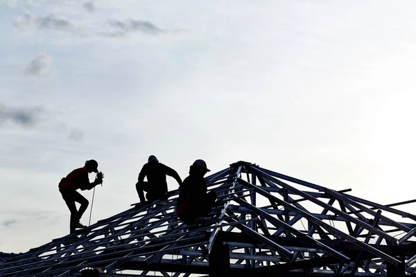 Contractor in Silhouette working on a Roof Top — Stock Photo, Image