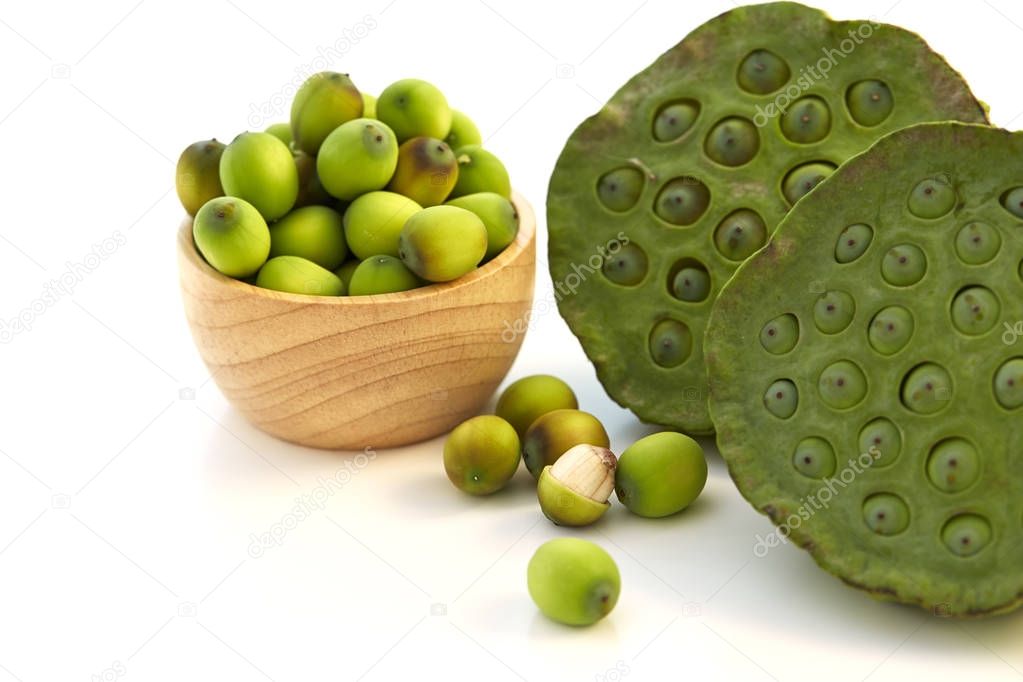 Lotus seeds put in a wooden cup on a white background