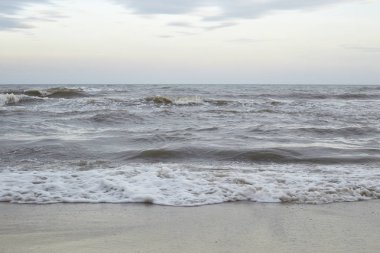 Güçlü dalgalar bir plajda. Gelen dalga deniz kenarında. Arka plan olarak kullanılabilir