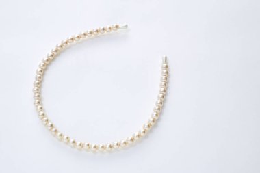 beyaz zemin üzerine inci saç bandı