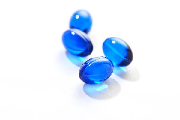 Blue pills capsule on white background — Stock Photo, Image