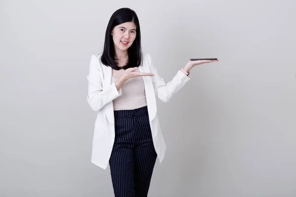 Businesswoman pointing her finger on white background — ストック写真