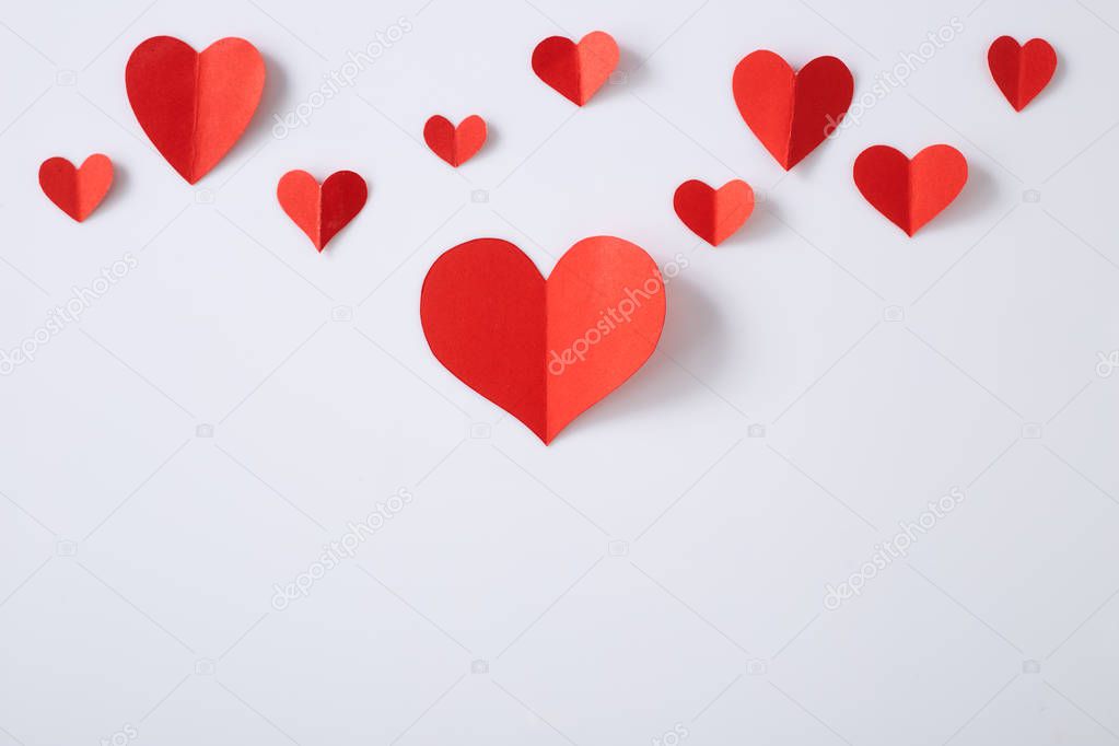 Red paper hearts on white background