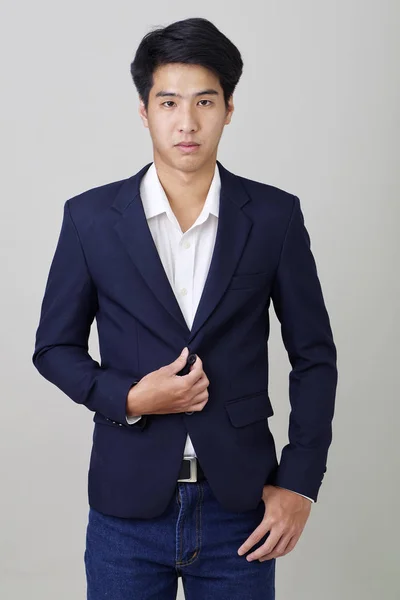 Portrait of fashionable asian entrepreneur on bright gray — Stok Foto