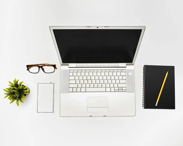 flat lay Office desktop with laptop and accessories on gray background with copy space