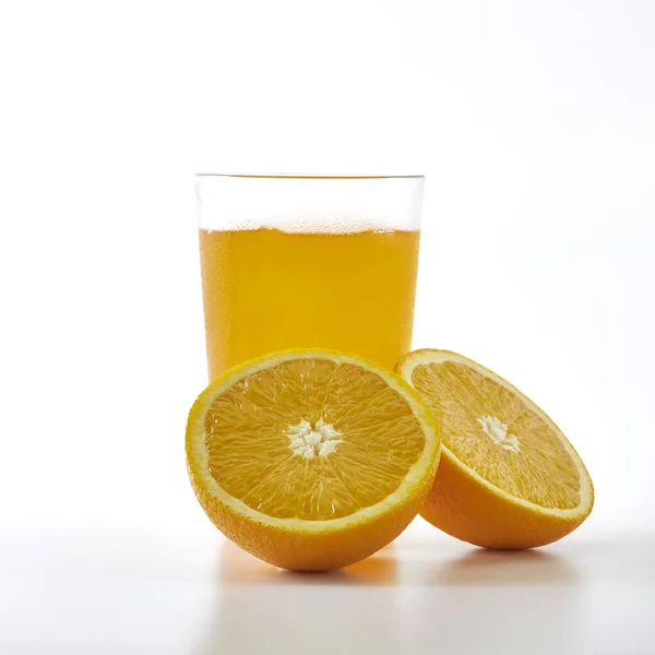 배경에 오렌지 주스와 오렌지 슬라이스 — 스톡 사진