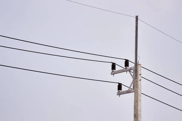 Electricity cable wire and cement pole with clear sky background