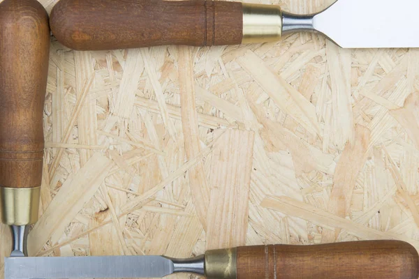 Professional chisels on a wooden background