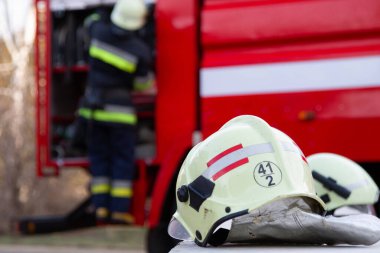 Fireman gear on fire truck. Firefighter helmet