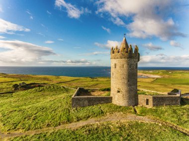 Aerial Famous Irish Tourist Attraction In Doolin, County Clare, Ireland. Doonagore Castle is a round 16th-century tower Castle. Aran Islands and along The Wild Atlantic Way. clipart