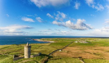 Aerial Famous Irish Tourist Attraction In Doolin, County Clare, Ireland. Doonagore Castle is a round 16th-century tower Castle. Aran Islands and along The Wild Atlantic Way. clipart