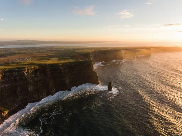 Aerial Ireland countryside tourist attraction in County Clare. The Cliffs of Moher sunset and castle Ireland. Epic Irish Landscape along the wild atlantic way. Beautiful scenic irish nature