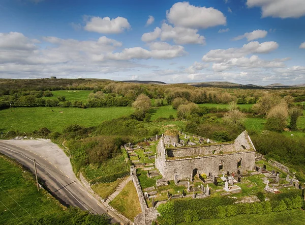 Aerial view of a beautiful old ruins of an Irish church and burial graveyard in county clare, Ireland. Set in the burren national park countryside landscape.