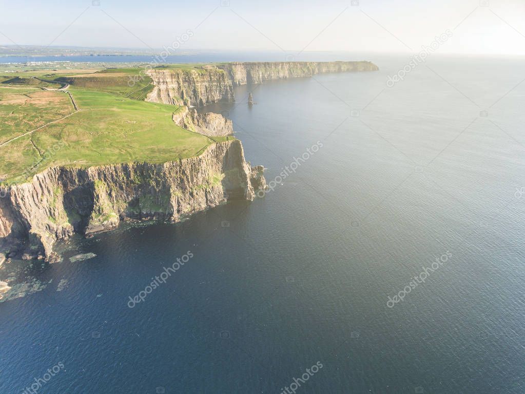 epic aerial from the cliffs of moher in county clare ireland. ireland's number 1 tourist attraction. beautiful scenic irish countryside landscape.