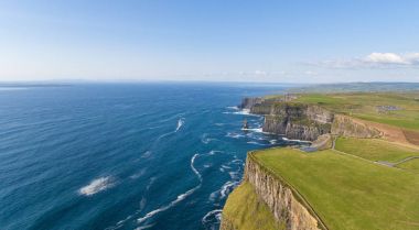 Aerial birds eye view from the world famous cliffs of moher in county clare ireland. beautiful irish scenic landscape nature in the rural countryside of ireland along the wild atlantic way. clipart