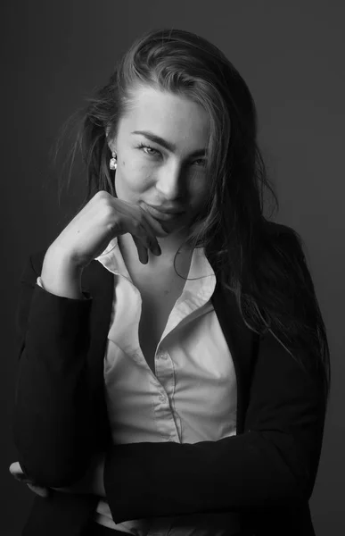High fashion Black and White portrait of young elegant sexy slim brunette woman posing in studio wearing fashionable black jacket suit and white shirt