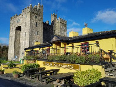 Bunratty Castle and Durty Nelly's Irish Pub, Ireland - Nov 30th 2017: Beautiful view of Ireland's most famous Castle and Irish Pub in County Clare. Famous world tourist attraction. Bunratty Castle and Durty Nelly's Pub. clipart