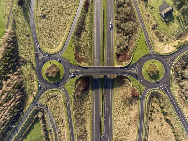 Aerial birds eye view of the M7 motorway in Ireland. Motorway with bridge, roundabouts, and movement. — Stock Photo, Image