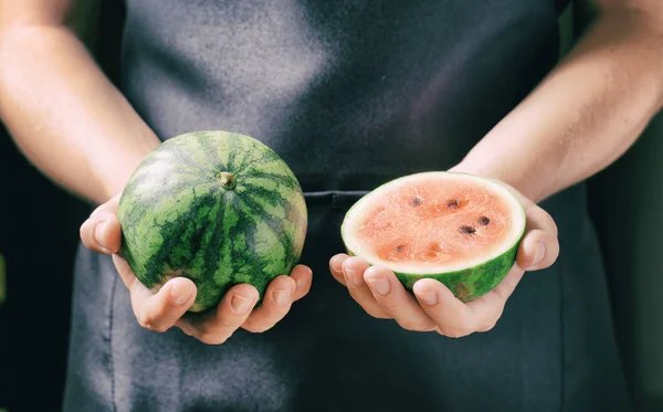 Fresh ripe juicy small watermelons in hands of woman — Stock Photo, Image