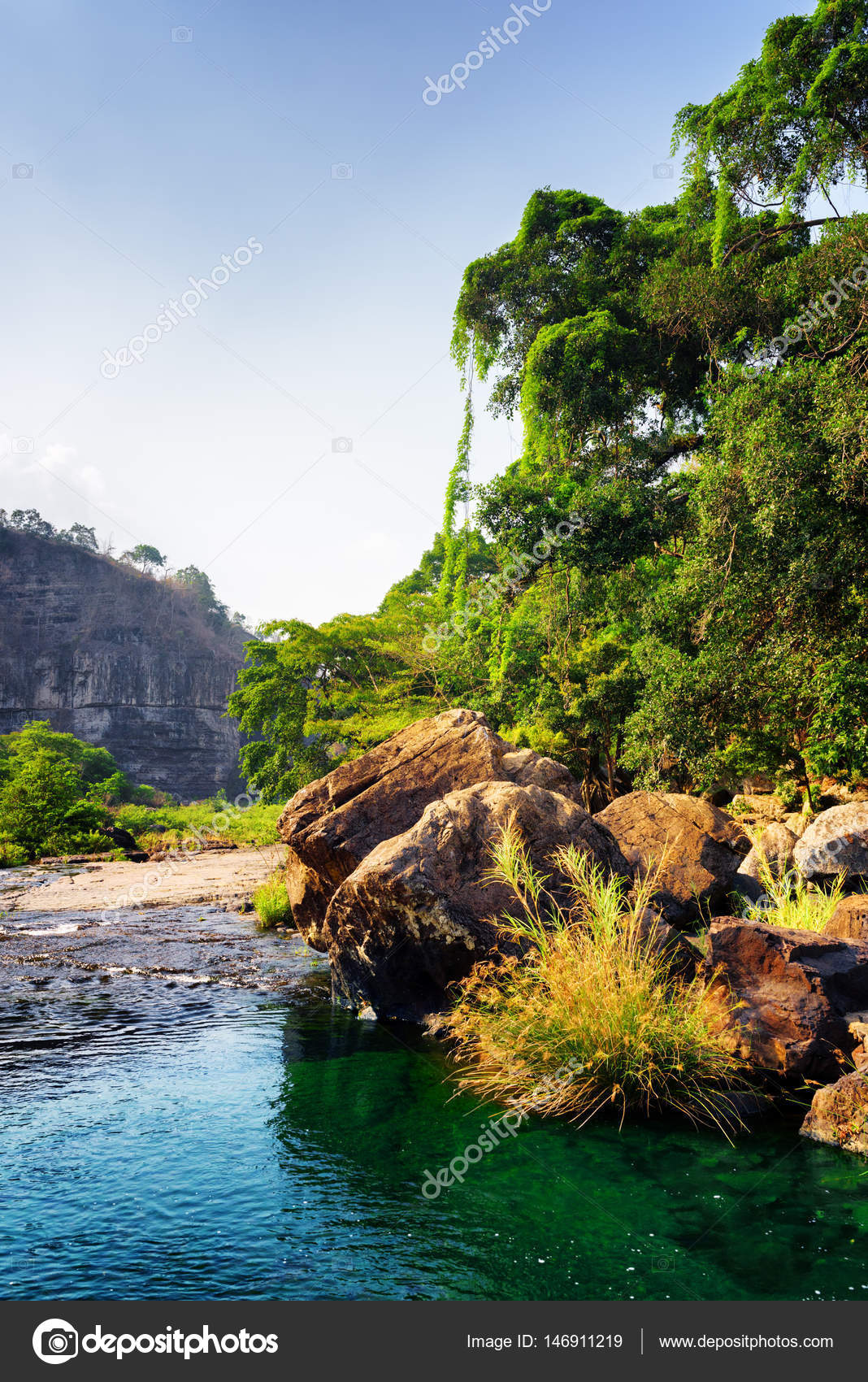 River With Emerald Crystal Clear Water Among Woods And Rocks