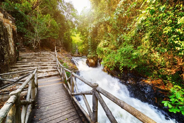 Wooden boardwalk and stone stairs leading along scenic river — Stock Photo, Image