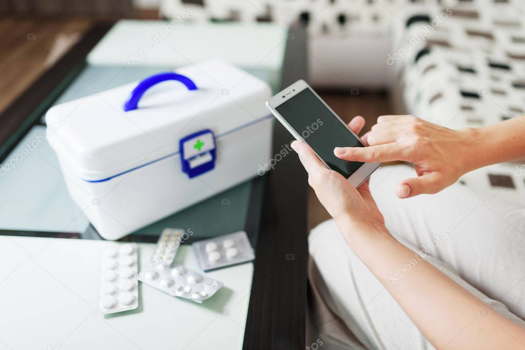 Woman using smartphone for buying pills online pharmacy