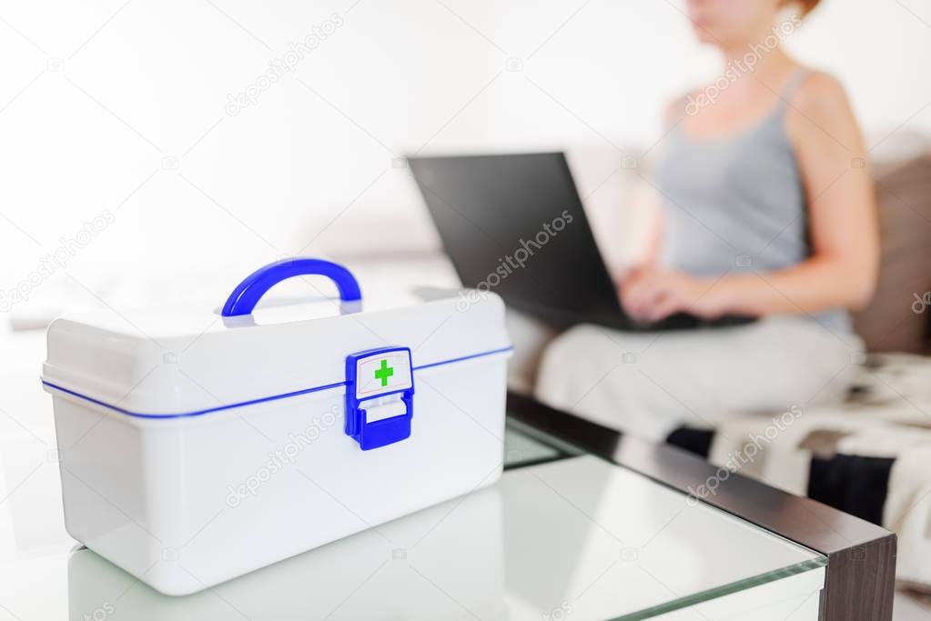 First aid kit. Woman buying drugs in online pharmacy