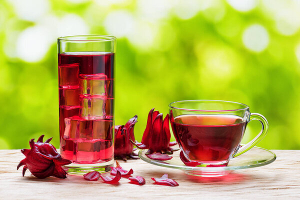 Cup of hot hibiscus tea and the same cold drink in glass