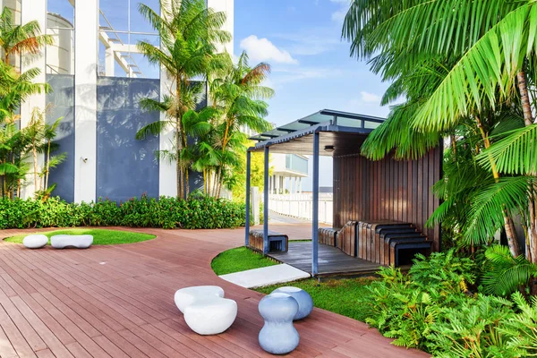 Hermoso jardín en la azotea. Moderno cenador de madera entre árboles verdes —  Fotos de Stock