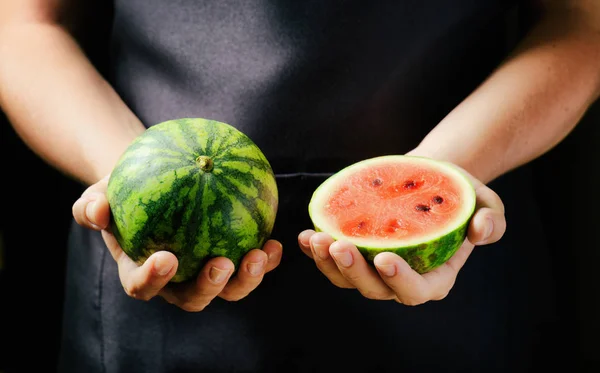 Fresh ripe juicy red small watermelons in hands of woman — Stock Photo, Image